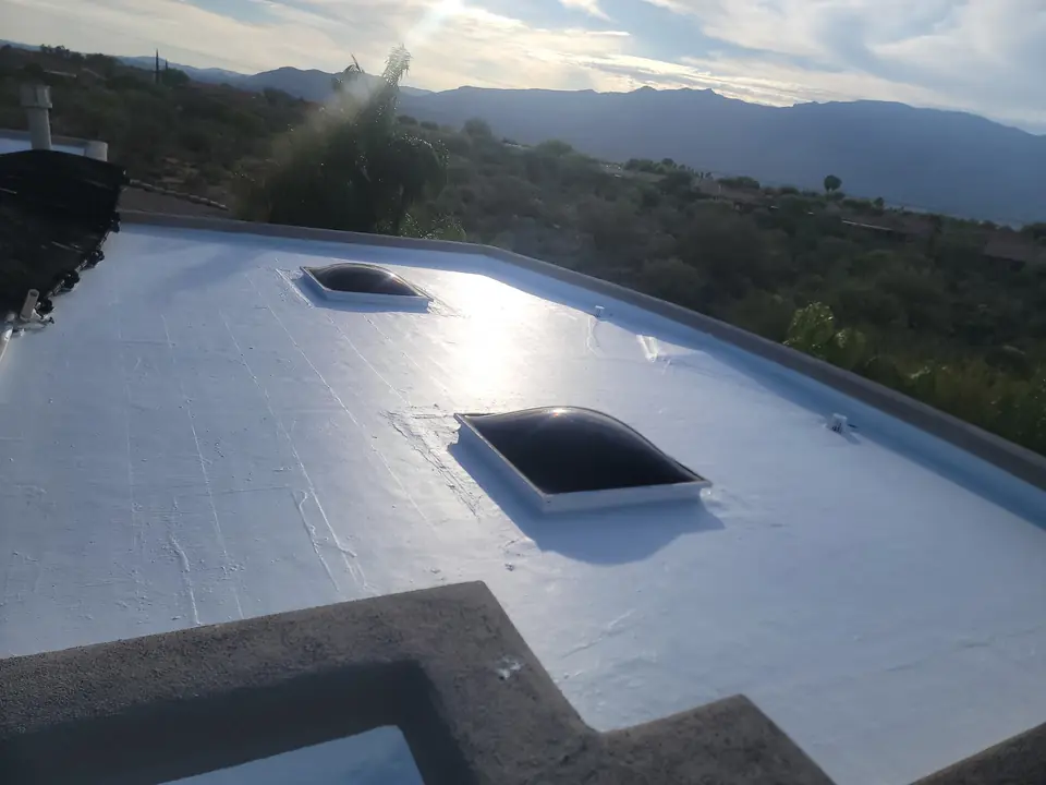 White reflective roof with two skylights and Southern Arizona mountains
